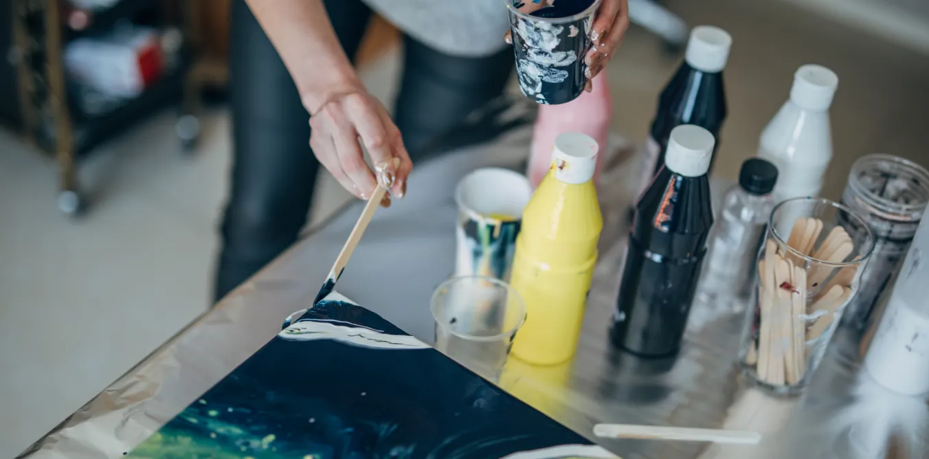 Photo of student painting on canvas
