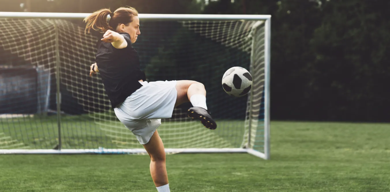 Photo of woman playing football