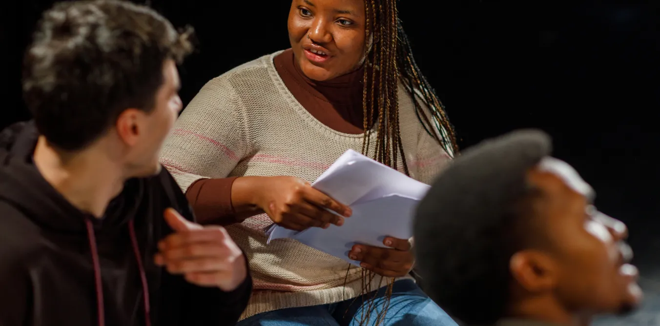 Photo of students in a drama class talking