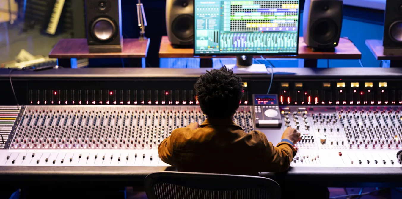 Photo of student working in music studio with equipment