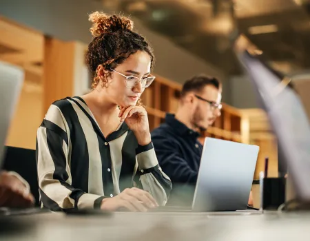 People in library on laptop