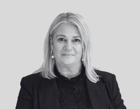 Black and white headshot of Lisa Mann - woman with light hair and dark blazer