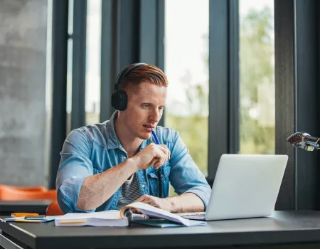 Man using laptop with headphones
