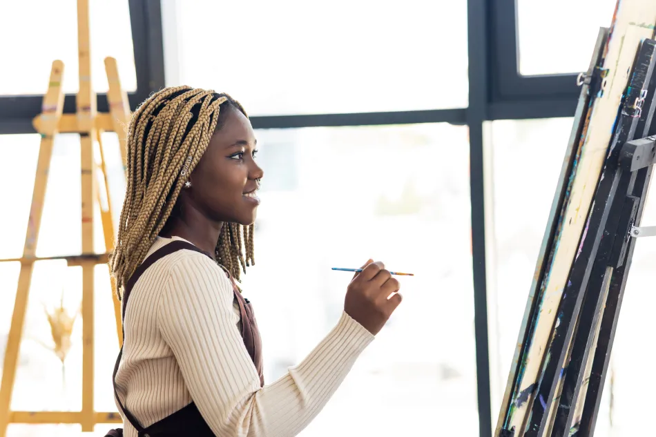 person painting on easel