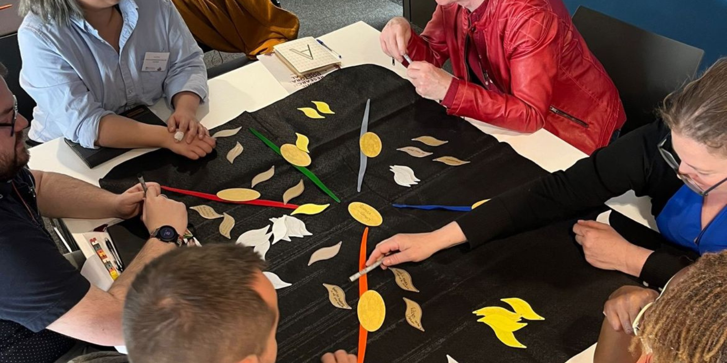 Photo of participants at workshop session around a table
