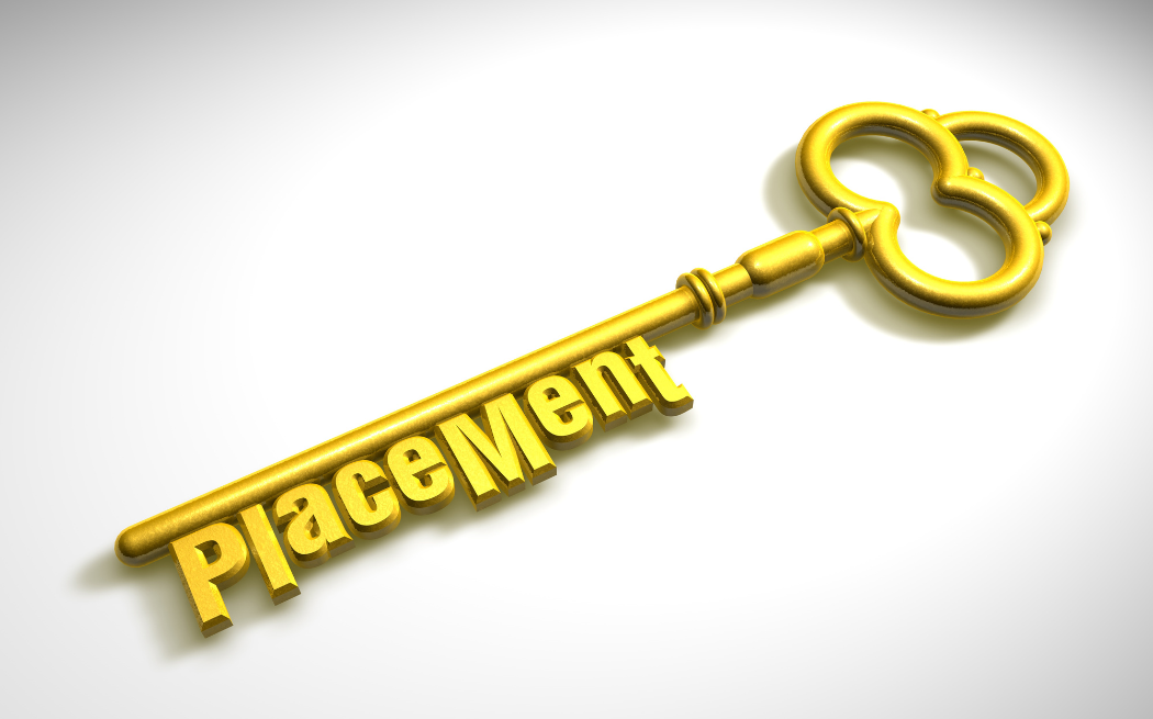 A gold key with the words 'placement' incorporated